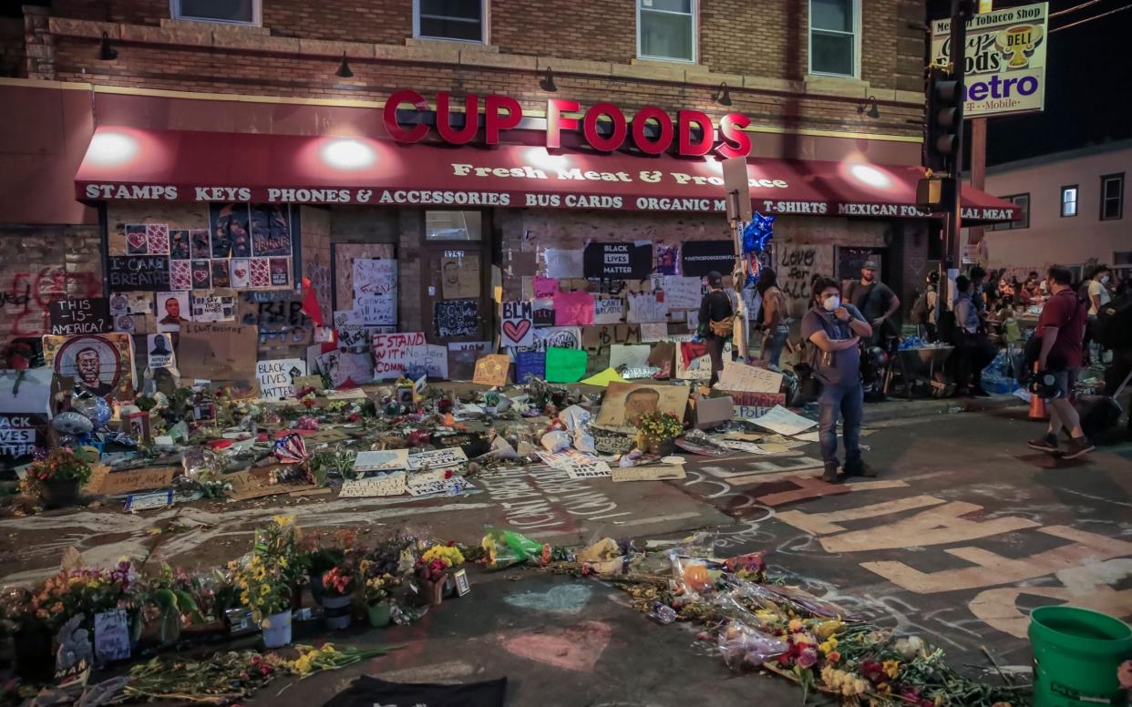 People participate in a sit-in protest after curfew at the site where George Floyd was arrested - Shutterstock 