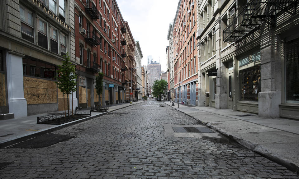 A SoHo street is deserted, Wednesday, June 3, 2020, in New York. There's a certain kind of silent on the streets of Manhattan. Not the "summertime and the living is easy" vacation lull, or the post-Christmas holidays letdown. It's the only-person-in-the-empty-house kind of quiet now. The New York City immortalized in song and scene has been swapped out for the last few months with the virus version. (AP Photo/Mark Lennihan)