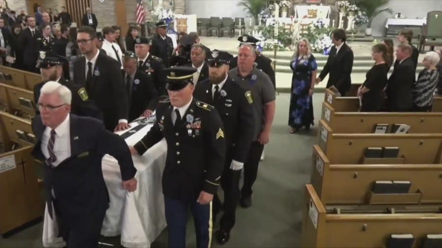 Officer Jacob Derbin’s casket departs St. Columbkille Church