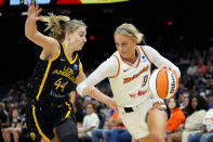 Phoenix Mercury guard Sophie Cunningham (9) drives as Los Angeles Sparks guard Karlie Samuelson defends during the first half of a WNBA preseason basketball game, Friday, May 12, 2023, in Phoenix. (AP Photo/Matt York)
