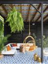 <p>Turning an empty backyard corner into paradise is easier than you may think. A colorful rug, a floating couch and plants pull together a space, but it'll be a porch swing that steals the show. </p><p><strong>RELATED:</strong> <a href="https://www.goodhousekeeping.com/home/gardening/g1809/decor-ideas-deck-porch/" rel="nofollow noopener" target="_blank" data-ylk="slk:Decor Tips for Your Patio or Backyard;elm:context_link;itc:0;sec:content-canvas" class="link ">Decor Tips for Your Patio or Backyard</a></p>