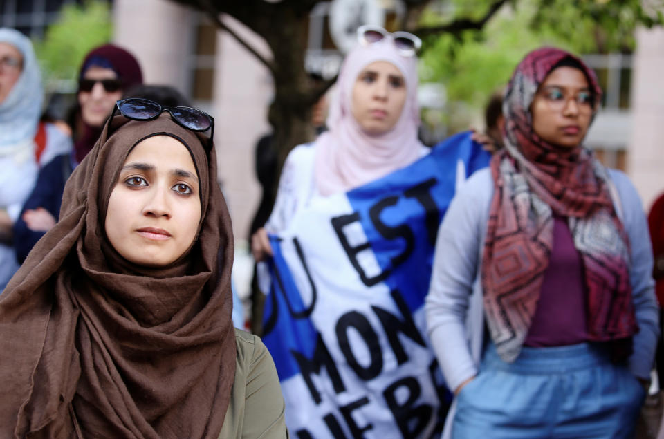 Women protest Quebec's new Bill 21, which will ban teachers, police, government lawyers and others in positions of authority from wearing religious symbols such as Muslim head coverings and Sikh turbans, in Montreal on June 17. (Photo: Christinne Muschi / Reuters)