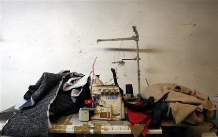 An industrial sewing machine is pictured as police officers conduct a check at the Shen Wu textile factory in Prato December 9, 2013. REUTERS/Stefano Rellandini