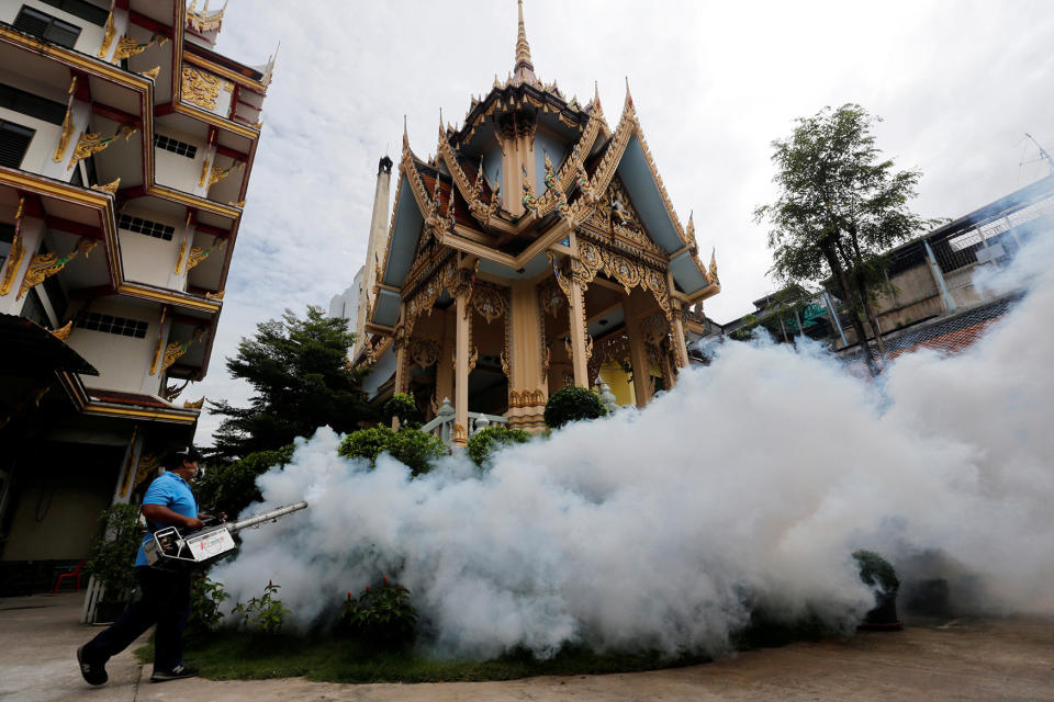 A city worker fumigates the area to control the spread in Bangkok