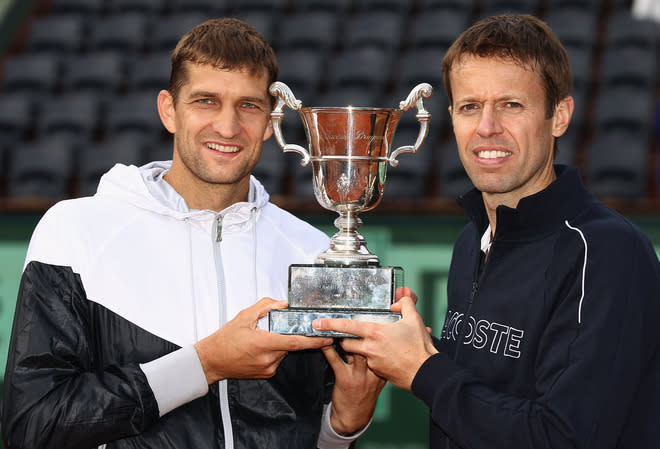 PARIS, FRANCE - JUNE 09: Max Mirnyi (L) of Belarus and Daniel Nestor of Canada pose with the winners trophy after defeating Bob and Mike Bryan of the USA in the men's doubles final during day 14 of the French Open at Roland Garros on June 9, 2012 in Paris, France. (Photo by Matthew Stockman/Getty Images)