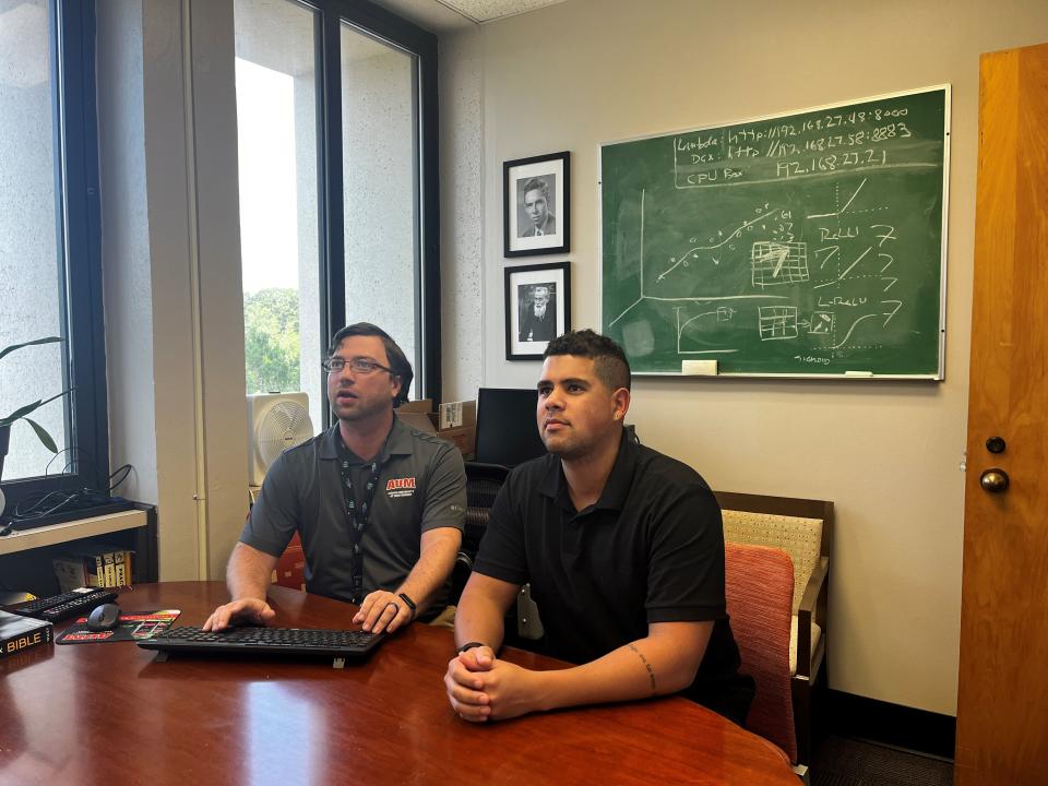 AUM students Rodney Easter Jr. and Guilherme Bittencourt conduct research in the AI lab.