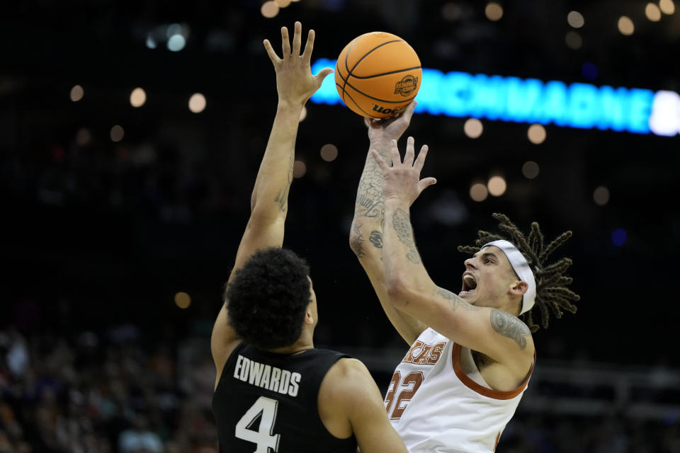 Texas forward Christian Bishop shoots over Xavier forward Cesare Edwards in the first half of a Sweet 16 college basketball game in the Midwest Regional of the NCAA Tournament Friday, March 24, 2023, in Kansas City, Mo. (AP Photo/Jeff Roberson)