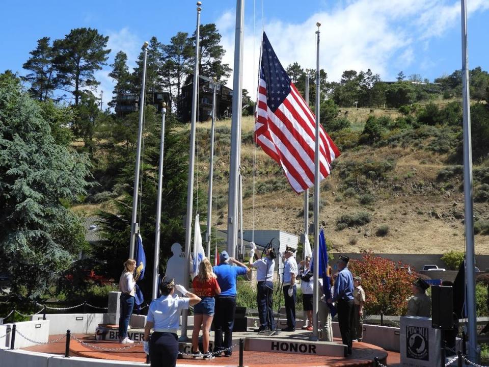 Military representatives and local students salute the raising of the American flag during a Memorial Day ceremony at the Cambria Veterans Memorial in 2019.