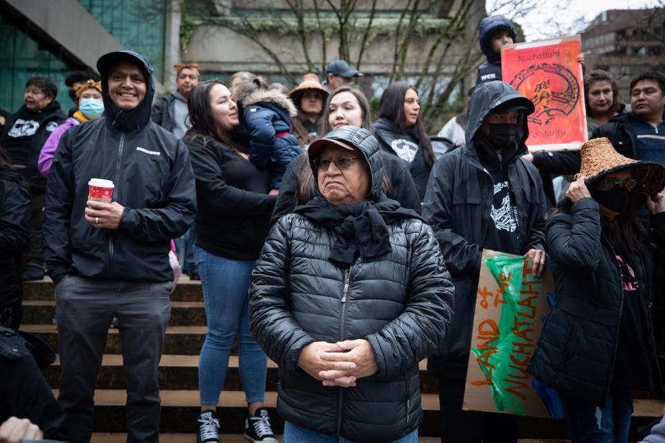 Nuchatlaht First Nation elder and councillor Archie Little, centre, and Tyee Ha'with (Chief) Jordan Michael, far left, stand with supporters outside B.C. Supreme Court before the start of their Indigenous land title case.