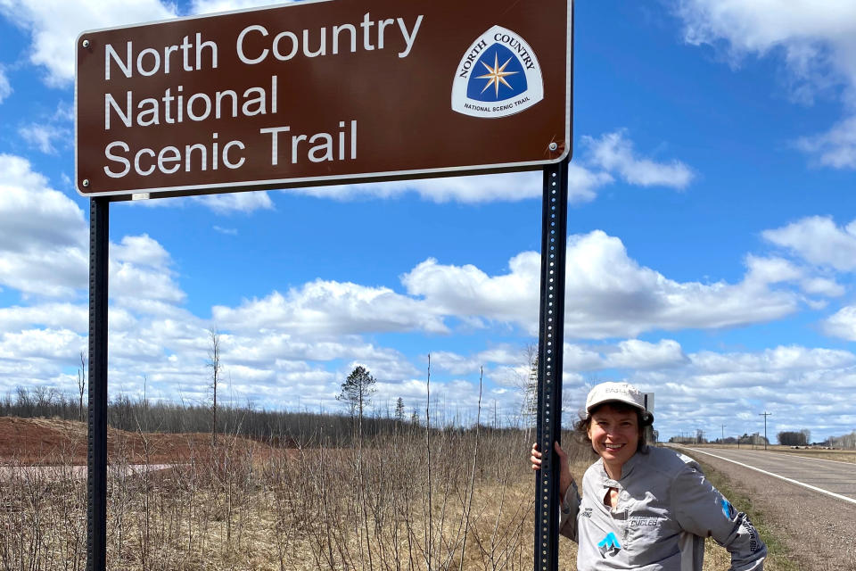 Andrea Larson at North Country Scenic Trail sign