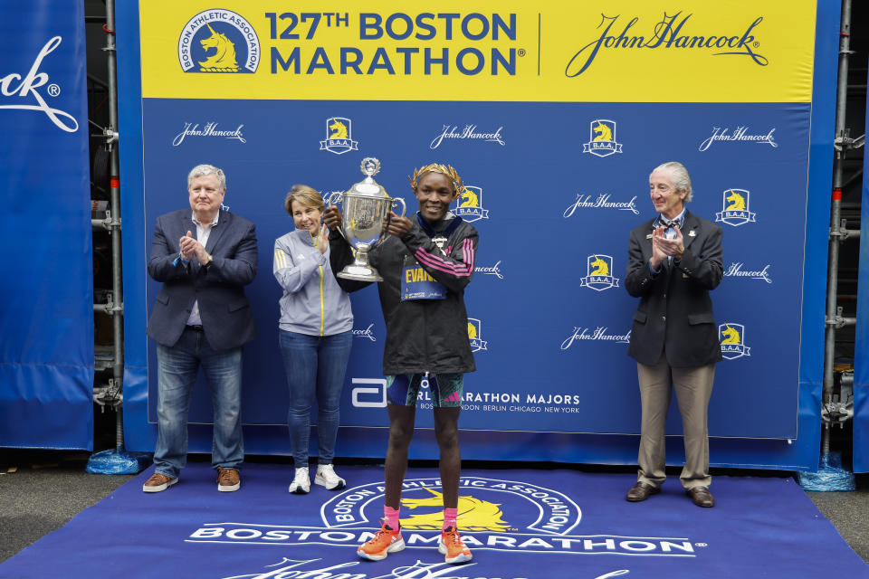 Evans Chebet of Kenya holds the trophy after winning the 127th Boston Marathon, Monday, April 17, 2023, in Boston. (AP Photo/Winslow Townson)