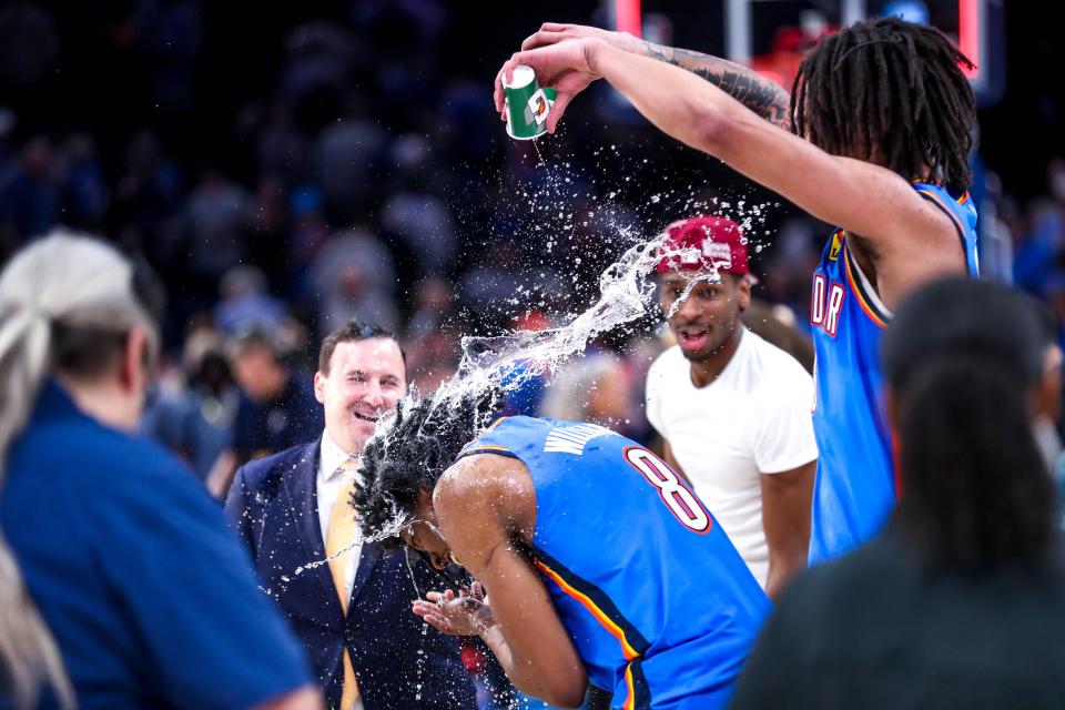 Thunder forward Jaylin Williams, right, dumps water on fellow rookie Jalen Williams (8) after making the winning shot to beat the Pistons 107-106 Wednesday night at Paycom Center.