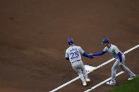 Toronto Blue Jays' Daulton Varsho, left, celebrates with third base coach Carlos Febles after hitting a three-run home run during the first inning of a baseball game against the San Diego Padres, Saturday, April 20, 2024, in San Diego. (AP Photo/Gregory Bull)