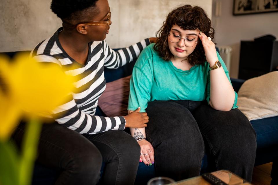 A woman being comforted by a friend