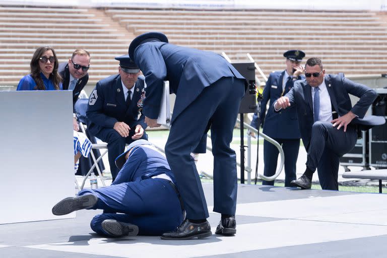 US President Joe Biden falls during the graduation ceremony at the United States Air Force Academy, just north of Colorado Springs in El Paso County, Colorado, on June 1, 2023. (Photo by Brendan Smialowski / AFP)