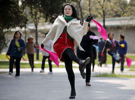 Women perform square dancing at a park square in Beijing, China, April 13, 2015. REUTERS/Kim Kyung-Hoon