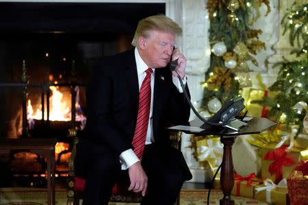 U.S. President Donald Trump participates in NORAD Santa tracker phone calls from the White House in Washington, U.S. December 24, 2018. REUTERS/Jonathan Ernst