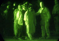 <p>U.S. Marines, shown through a night vision scope, escort battle field detainees into a detention center at Kandahar International Airport, Dec. 18, 2001. (Photo: USMC, Sgt. Thomas Michael Corcoran/Reuters) </p>