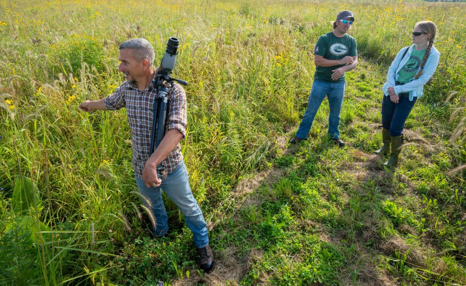 Oneida Nation wetlands project manager Tony Kuchma, left, non point program project manager Wes Johnson and UW-Green Bay senior research specialist and president of the Northeastern Wisconsin Audubon Society Erin Giese walk through a restored prairie August 23 at the headwaters of a tributary Trout Creek on the Oneida Reservation in Oneida, Wis. This is part of a 412-acre restored natural area.