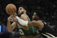 Milwaukee Bucks' Malik Beasley knocks the ball from Boston Celtics' Jayson Tatum during the first half of an NBA basketball game Tuesday, April 9, 2024, in Milwaukee. (AP Photo/Morry Gash)