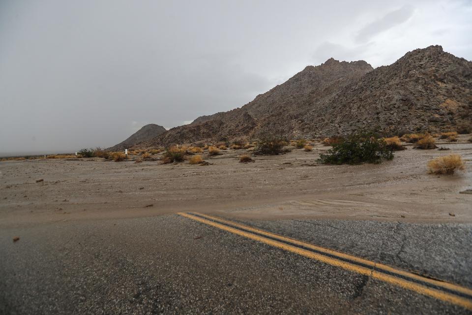 A flash flood inundates Amboy Road with water near the Sheephole Mountains about 25 miles away from Twentynine Palms, Calif., on August 24, 2022. Heavy rain from thunderstorms affected some roads and interstates on Wednesday. Traffic was moving on eastbound Interstate 10 east of Desert Center in a single lane that was reopened Thursday morning after the road was closed for several hours by flooding from a storm and an overturned truck.