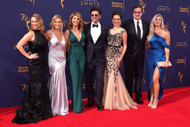 From left: Andrea Barber, Candace Cameron Bure, Lori Loughlin, John Stamos, Caitlin McHugh, Bob Saget and Kelly Rizzo pose at the Emmy Awards.