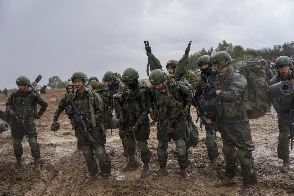 Israeli soldiers prepare to enter the Gaza Strip, at a staging area near the Israeli-Gaza border, in southern Israel, Wednesday, Dec. 13, 2023. The army is battling Palestinian militants across Gaza in the war ignited by Hamas' Oct. 7 attack into Israel. (AP Photo/Ohad Zwigenberg)