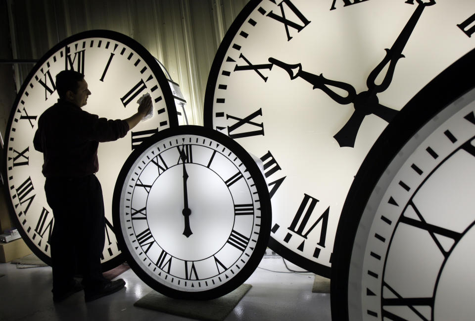 FILE - This photo by Associated Press photographer Elise Amendola shows Electric Time Co. employee Walter Rodriguez cleaning the face of an 84-inch Wegman clock at the plant in Medfield, Mass. Thursday, Oct. 30, 2008. Amendola, who recently retired from the AP, died Thursday, May 11, 2023, at her home in North Andover, Mass., after a 13-year battle with ovarian cancer. She was 70. (AP Photo/Elise Amendola, File)