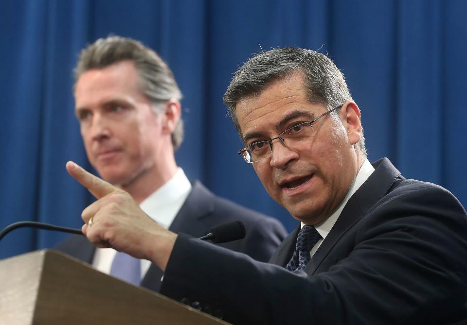 California Attorney General Xavier Becerra, right, accompanied by Gov. Gavin Newsom, leads a group of 20 state attorneys general suing President Trump over his border wall emergency declaration.
