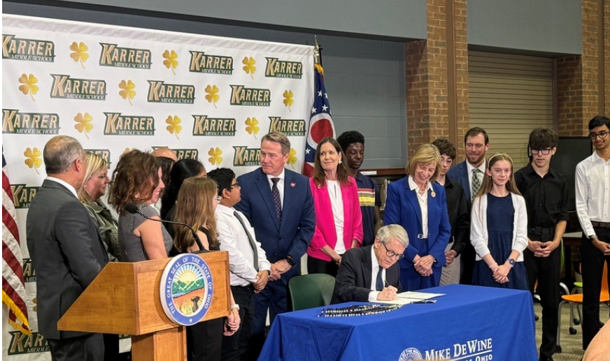 Ohio Gov. Mike DeWine signed a bill Wednesday at Karrer Middle School in Dublin that will require K-12 districts to implement cell phone policies that reduce student use during the school day.