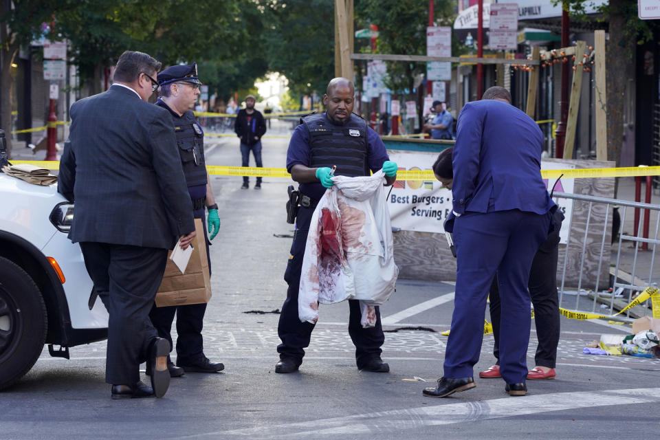 Philadelphia police at the scene Sunday of a fatal overnight shooting.  (Michael Perez / AP)