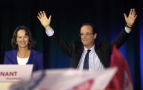 FILE - In this April 4, 2012 file photo, French Socialist Party candidate for the 2012 presidential elections Francois Hollande, and former Socialist presidential candidate Segolene Royal, left, wave during a campaign meeting in Rennes, western France. Royal, French President Francois Hollande's former partner, has been named Wednesday, April, 2, 2014 as Minister of Environment and Energy. (AP Photo/Christophe Ena, File)