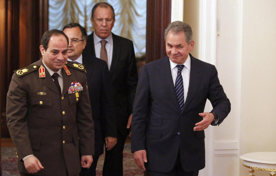 Egypt’s military chief Field Marshal Abdel-Fattah el-Sissi, left, and Egyptian Foreign Minister Nabil Fahmy, second left, are escorted by Russian Defense Minister Sergei Shoigu, right, and Russian Foreign Minister Sergey Lavrov as they enter a hall for their two-plus-two talks in Moscow, Russia, Thursday, Feb. 13, 2014. Egypt’s military chief visits Russia on his first trip abroad since ousting the Islamist president, part of a shift to reduce reliance on the United States at a time of frictions between the longtime allies. (AP Photo/Alexander Zemlianichenko)