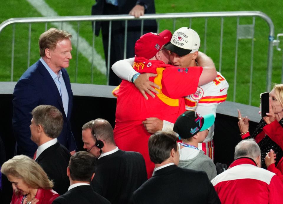 Kansas City Chiefs head coach Andy Reid hugs quarterback Patrick Mahomes (15) after defeating the Philadelphia Eagles as NFL commissioner Roger Goodell looks on in Super Bowl LVII at State Farm Stadium in Glendale on Feb. 12, 2023.