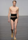 <b>London Fashion Week AW13: Central St Martins MA</b><br><br>A male model shows off some black pants and a weird chest band.<br><br>© Getty