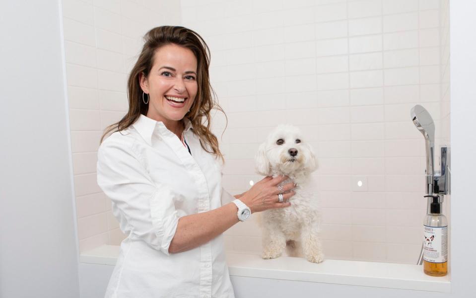 Interior designer Simone Suss with Daisy, in her bespoke dog shower - Rii Schroer