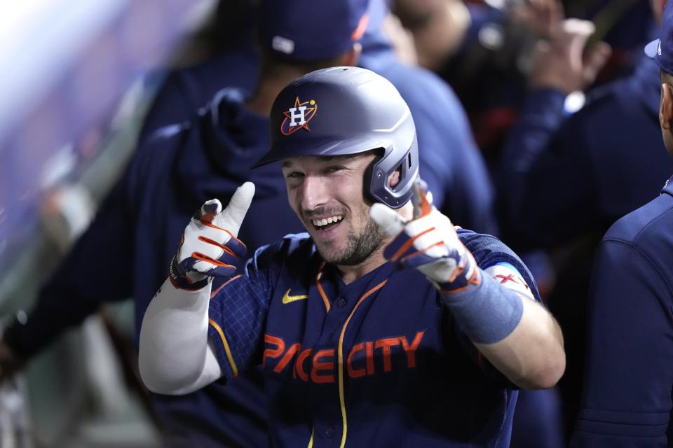 Houston Astros' Alex Bregman celebrates in the dugout after hitting a two-run home run against the Chicago Cubs during the seventh inning of a baseball game Monday, May 15, 2023, in Houston. (AP Photo/David J. Phillip)