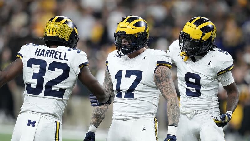 Michigan defensive end Braiden McGregor (17) celebrates with teammate defensive end Jaylen Harrell (32) and defensive back Rod Moore (9) after forcing a fumble during the second half of the Big Ten championship NCAA college football game against Iowa, Saturday, Dec. 2, 2023, in Indianapolis. 