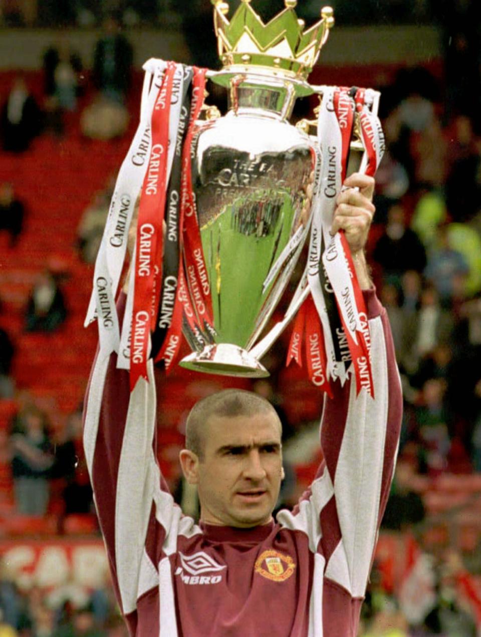 Manchester United team captain Eric Cantona holds the Premiership Trophy aloft at Old Trafford stadium Sunday May 11, 1997, where they finished the season with a 1-0 win against West Ham. (AP Photo / Tony Spencer)