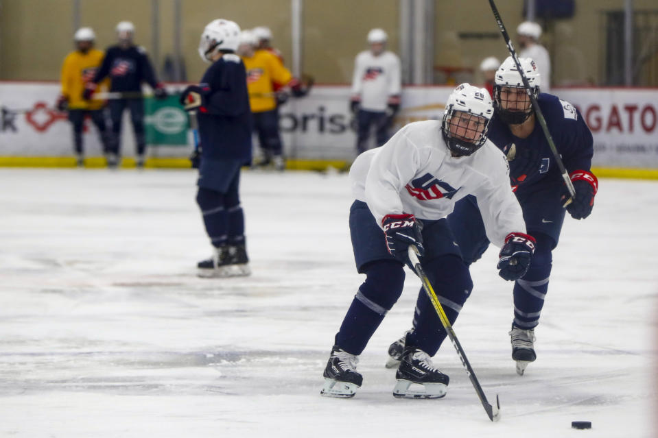 In this photo taken Monday, Nov. 4, 2019, Kendall Coyne-Schofield, center, a member of the U.S. Women's National hockey team, goes through drills during their practice in Cranberry Township, Butler County, Pa. While the WNBA continues to grow and women's professional soccer is capitalizing off a World Cup bump, women's hockey remains at a standstill with top players opting not to play professionally in North America in hopes of eventually creating a sustainable league with salaries that allow them to focus on their game and not just getting by. "For me, my clock is ticking," Schofield said. "But if I can leave this game better than it was, that's what's most important." (AP Photo/Keith Srakocic)
