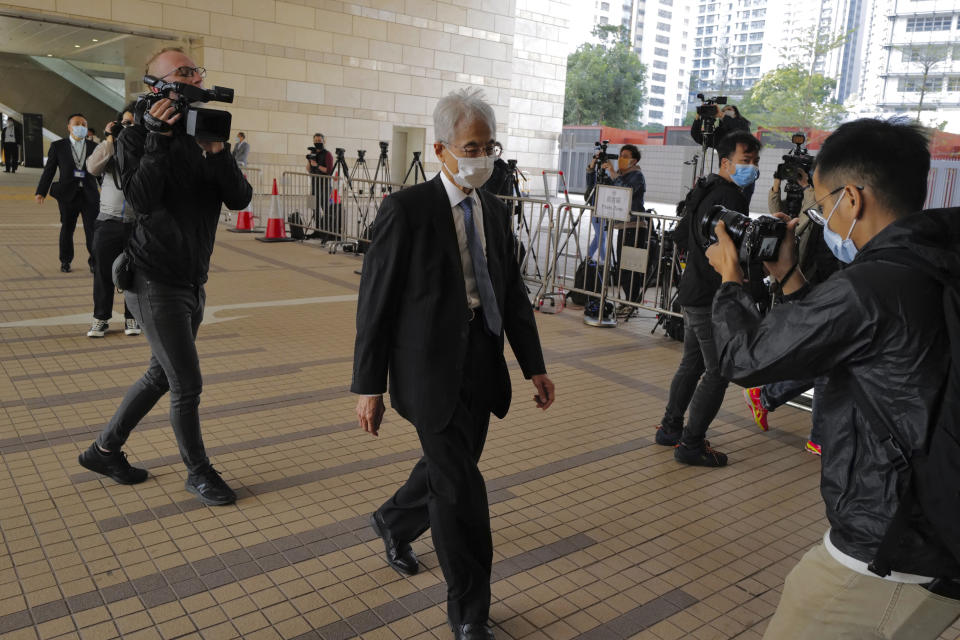 Pro-democracy lawmaker Martin Lee, center, arrives at a court in Hong Kong Tuesday, Feb. 16, 2021. Nine prominent Hong Kong's democracy advocates faced trial Tuesday on charges of organizing an unauthorized assembly in August 2019. Among the defendants veteran octogenarian lawyer and dubbed Hong Kong's "father of democracy" Lee and media tycoon Jimmy Lai. (AP Photo/Vincent Yu)