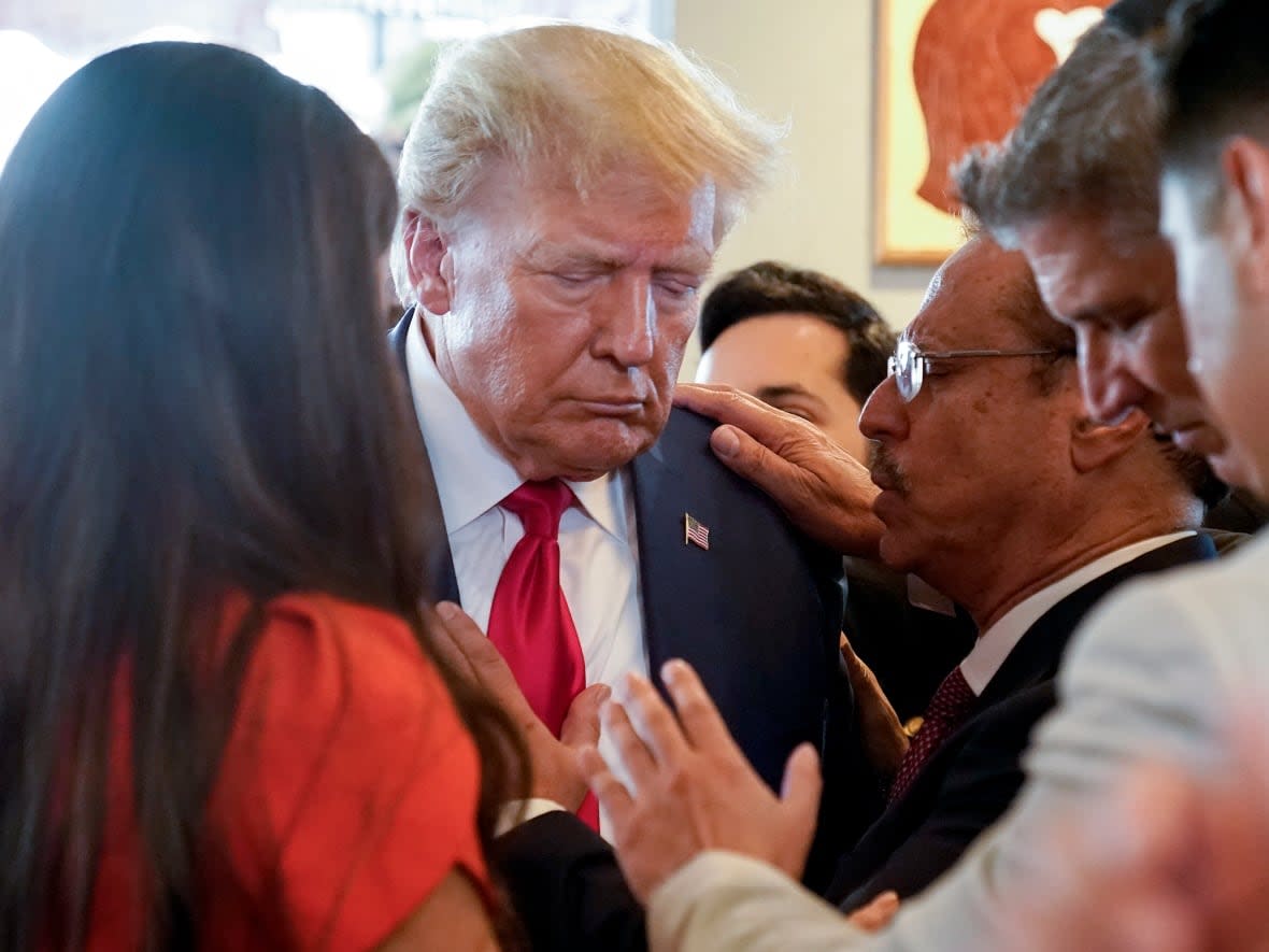 After being charged in court, Donald Trump went to a famous Miami cafe popular with conservative and anti-socialist Cuban expats, where patrons regaled him by singing Happy Birthday and prayed with him.  (Alex Brandon/The Associated Press - image credit)