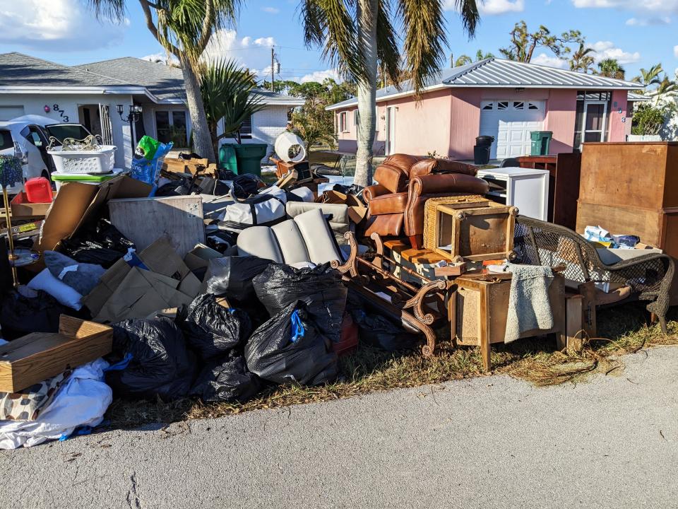 Piles of debris line West Valley Drive in Bonita Shores. Almost all the contents of these homes are now along the road ready for trash pick-up