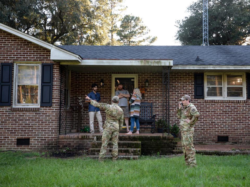 Airmen from Joint Base Charleston speak to a family living right next to the site of a crashed F-35 about the operation to recover the fighter jet and requests for the family in Williamsburg County, S.C., on Monday, Sept. 18, 2023.