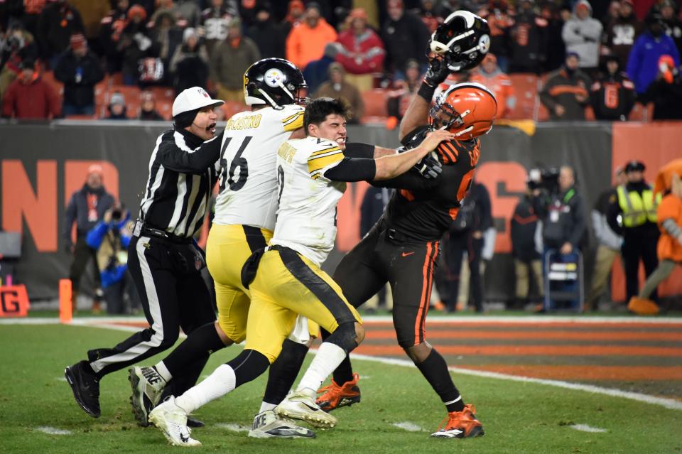 Cleveland Browns defensive end Myles Garrett swings Pittsburgh Steelers quarterback Mason Rudolph’s helmet at him on Nov. 14, 2019, in Cleveland.