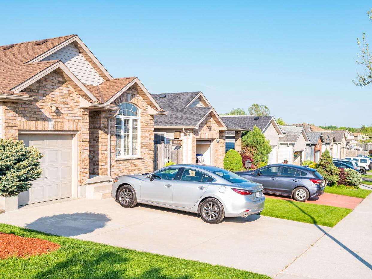 New residential neighborhood with row of detached houses in London Ontario Canada on a sunny day.