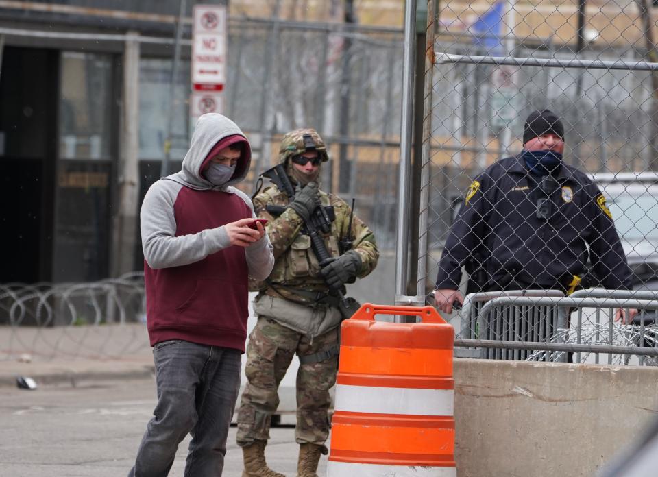 A member of the Minnesota National Guard and a police officer patrol an intersection in downtown Minneapolis shortly before jurors were set to begin deliberations in the murder trial of former police officer Derek Chauvin.