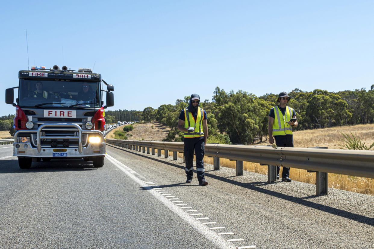 In this photo provided by the Department of Fire and Emergency Services, its members search for a radioactive capsule believed to have fallen off a truck being transported on a freight route on the outskirts of Perth, Australia, Saturday, Jan. 28, 2023. A mining corporation on Sunday apologized for losing the highly radioactive capsule over a 1,400-kilometer (870-mile) stretch of Western Australia, as authorities combed parts of the road looking for the tiny but dangerous substance. (Department of Fire and Emergency Services via AP)