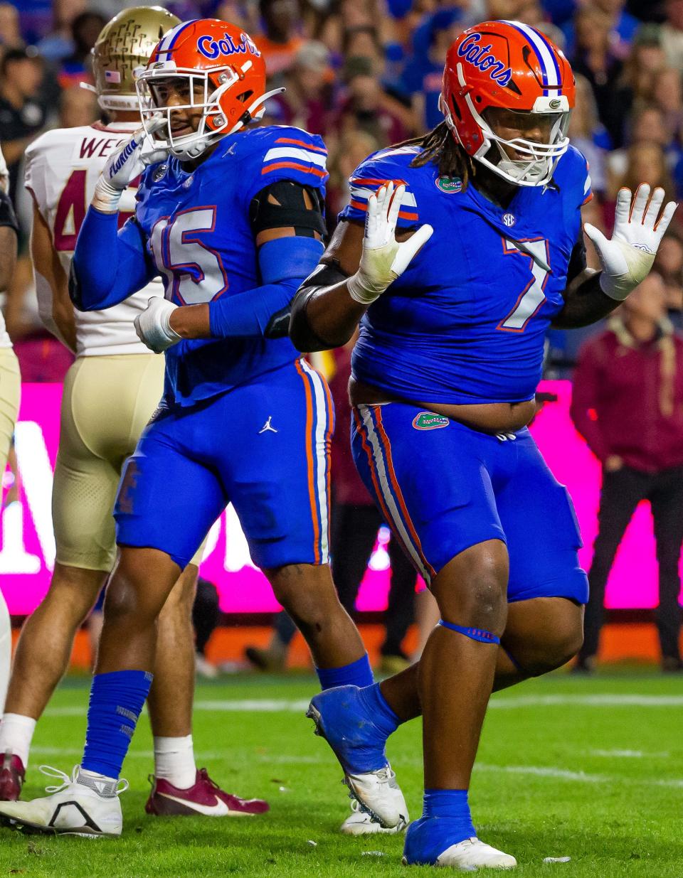 Florida Gators defensive lineman Chris McClellan (7) celebrates his tackle against Florida State Seminoles running back Trey Benson (3) on Steve Spurrier Field at Ben Hill Griffin Stadium in Gainesville, FL on Saturday, November 25, 2023 , during the second half.  Florida State won 24-15. [Doug Engle/Gainesville Sun]