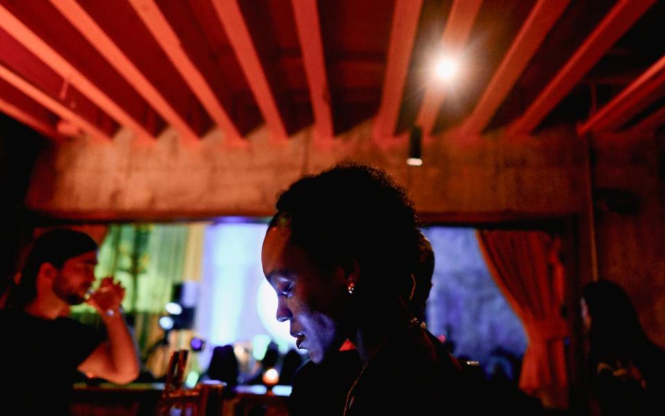 Guests order drinks at the bar during a recent Record Club event dedicated to John Mayer's 2006 album, "Continuum."